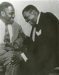 Art Tatum and Oscar Peterson sit close and share a laugh