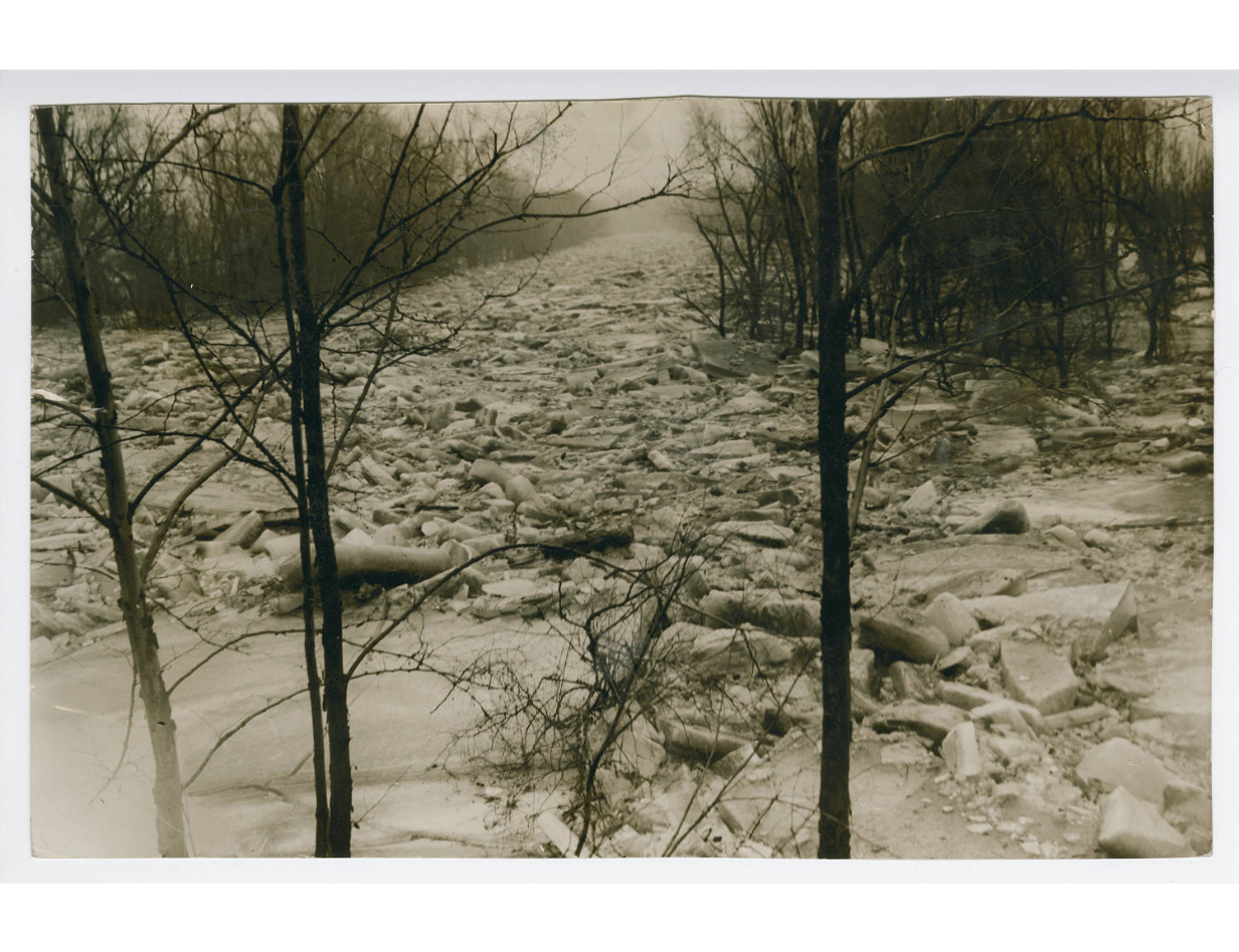 black and white view of an ice jam between the trees