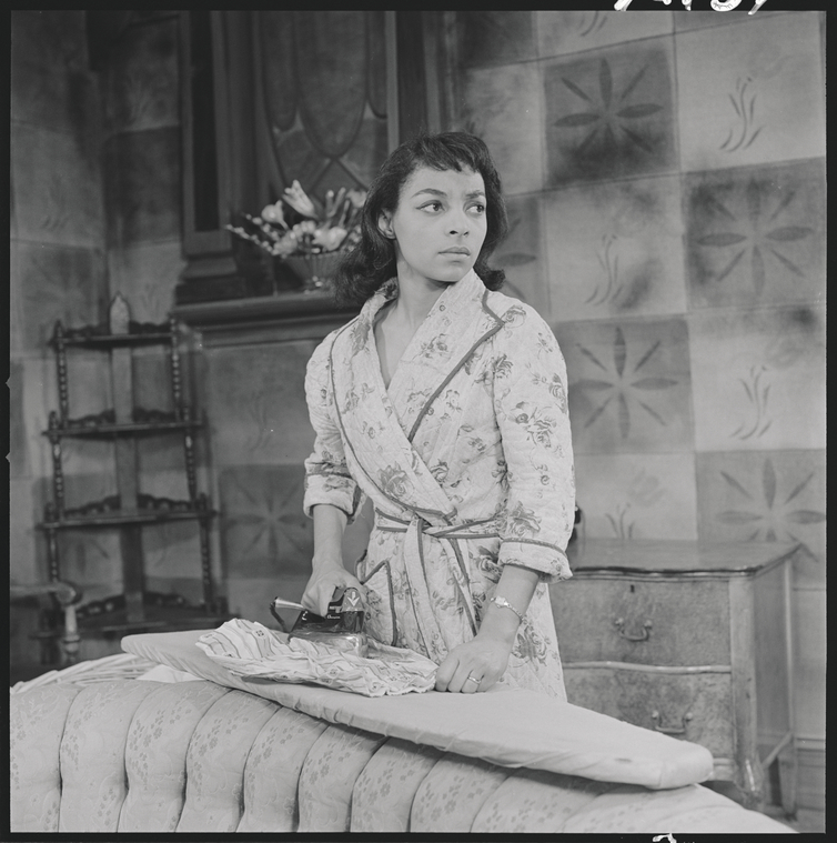 Ruby Dee (at ironing board) in the stage production Raisin in the Sun Preview